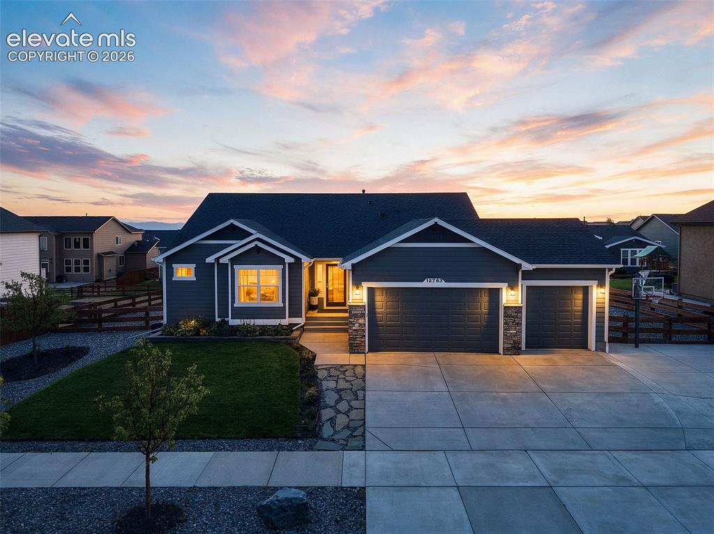 Image 1 of 49: Welcoming curb appeal with a spacious three-car garage and beautifully main