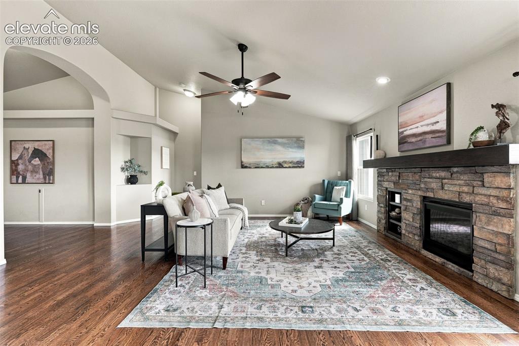 Image 15 of 49: Main-level living area with fireplace and generous room for entertaining.