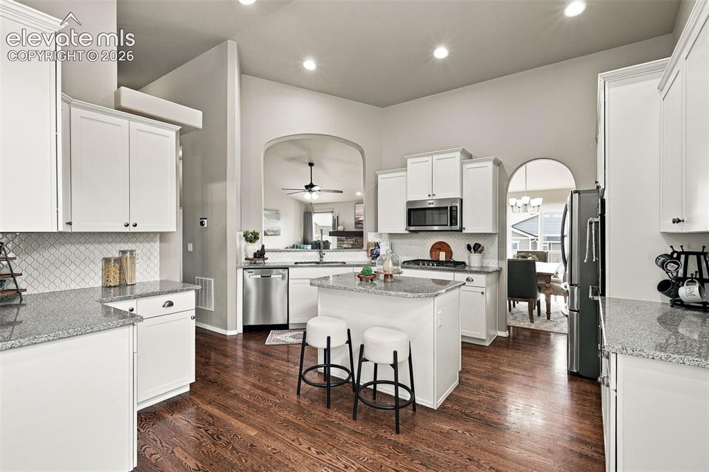 Image 19 of 49: Gourmet kitchen with abundant cabinetry, generous prep space and island sea