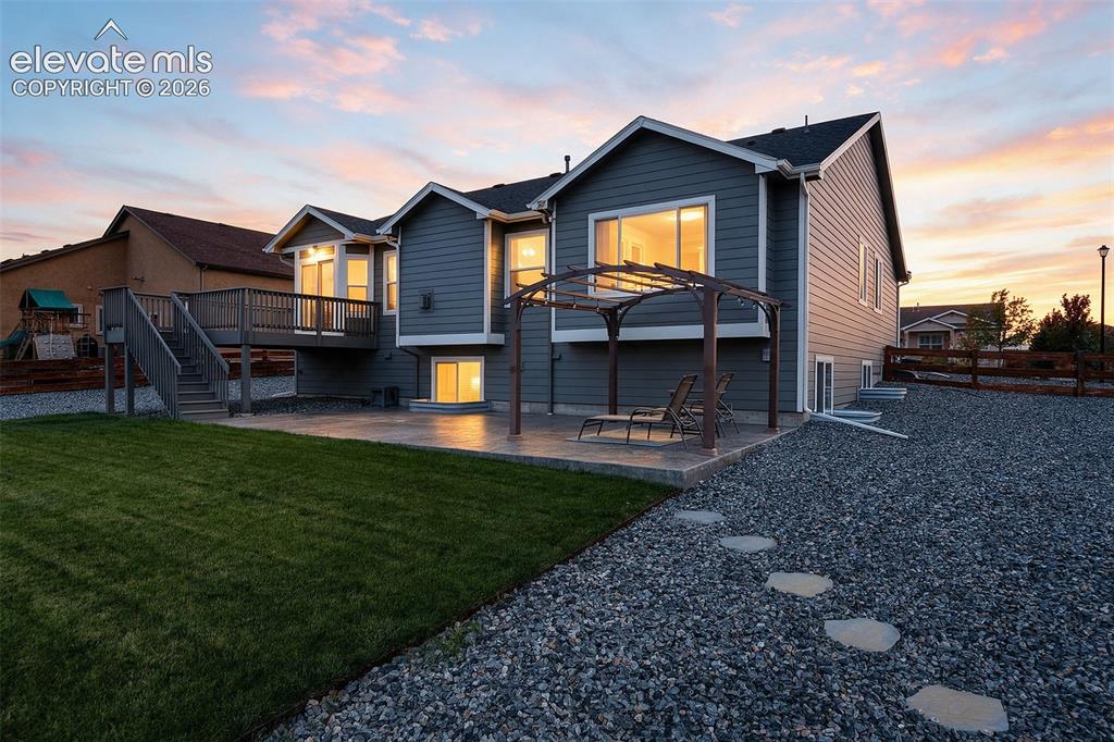 Image 2 of 49: Evening exterior showcasing the home’s warm, inviting curb appeal.