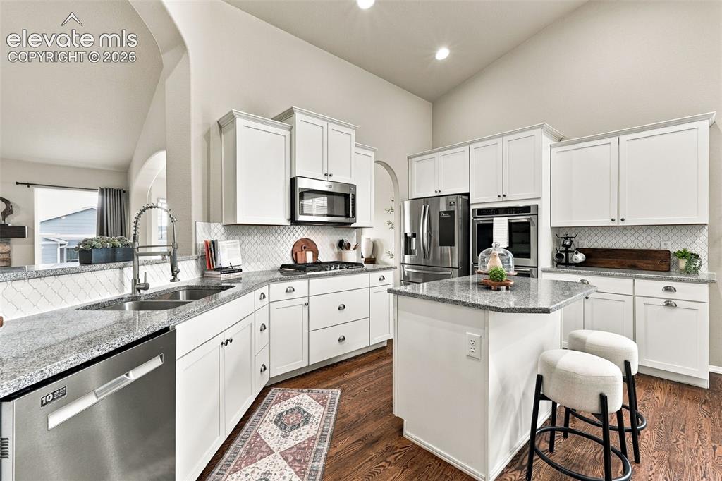 Image 20 of 49: Bright kitchen with extensive cabinetry and plenty of counter space.