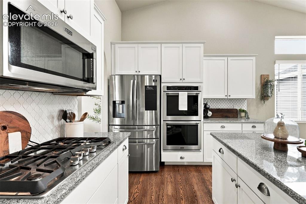Image 21 of 49: Well-appointed kitchen with stainless steel appliances and abundant storage