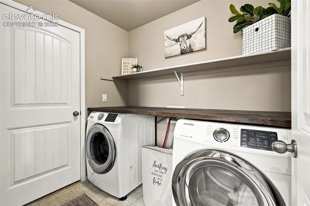 Image 22 of 49: Main level laundry with access directly to the garage.