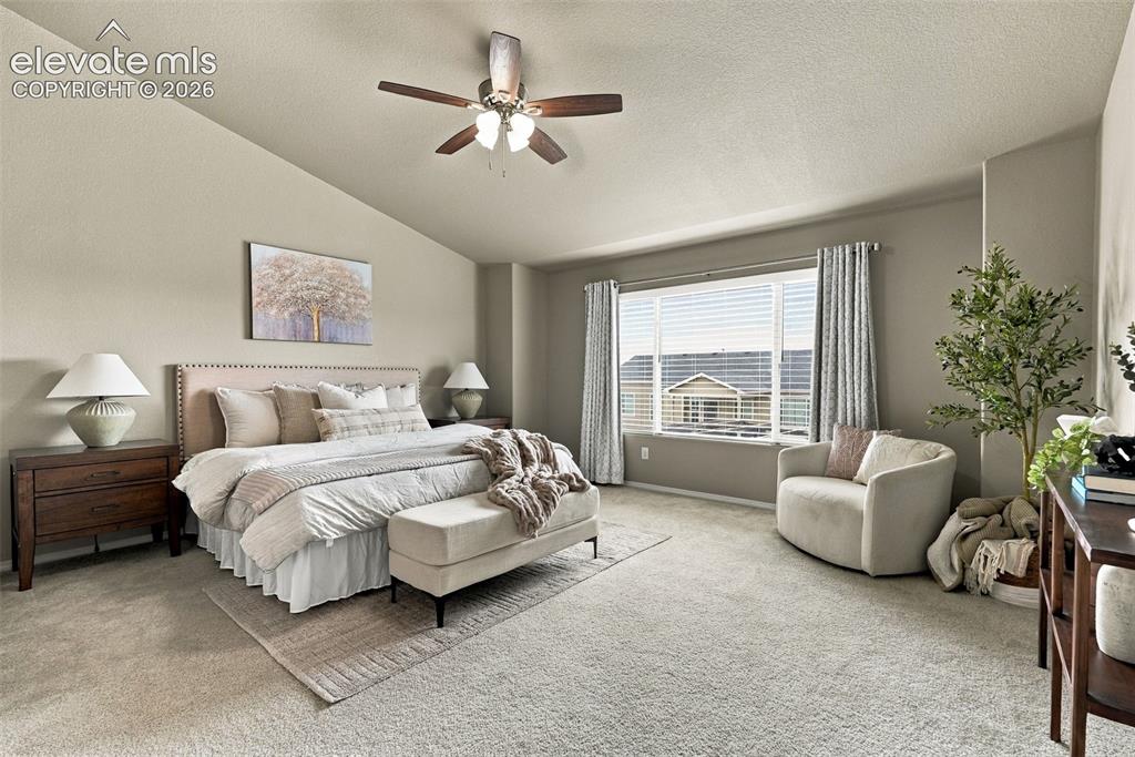 Image 25 of 49: Spacious main-floor primary suite with room for a sitting area.