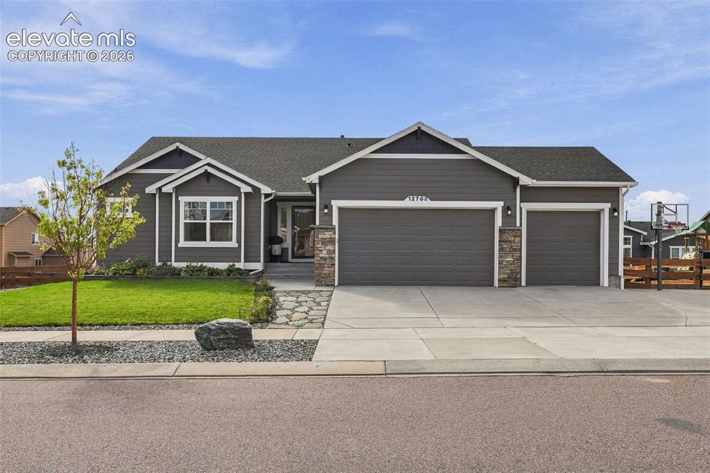 Image 3 of 49: Ranch-style home with three-car garage and extended driveway for additional