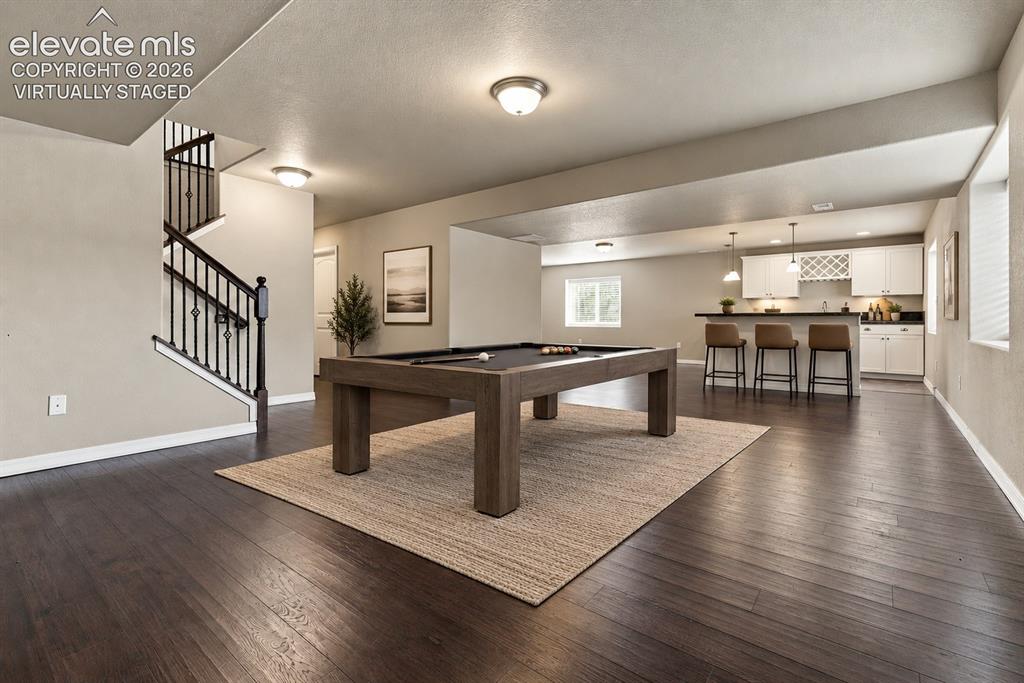 Image 35 of 49: Virtually staged to showcase the basement’s potential as a game and enterta