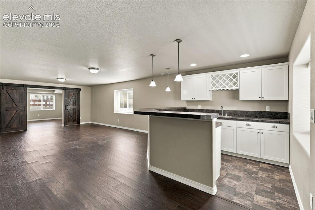 Image 36 of 49: Basement wet bar makes this level ideal for entertaining.
