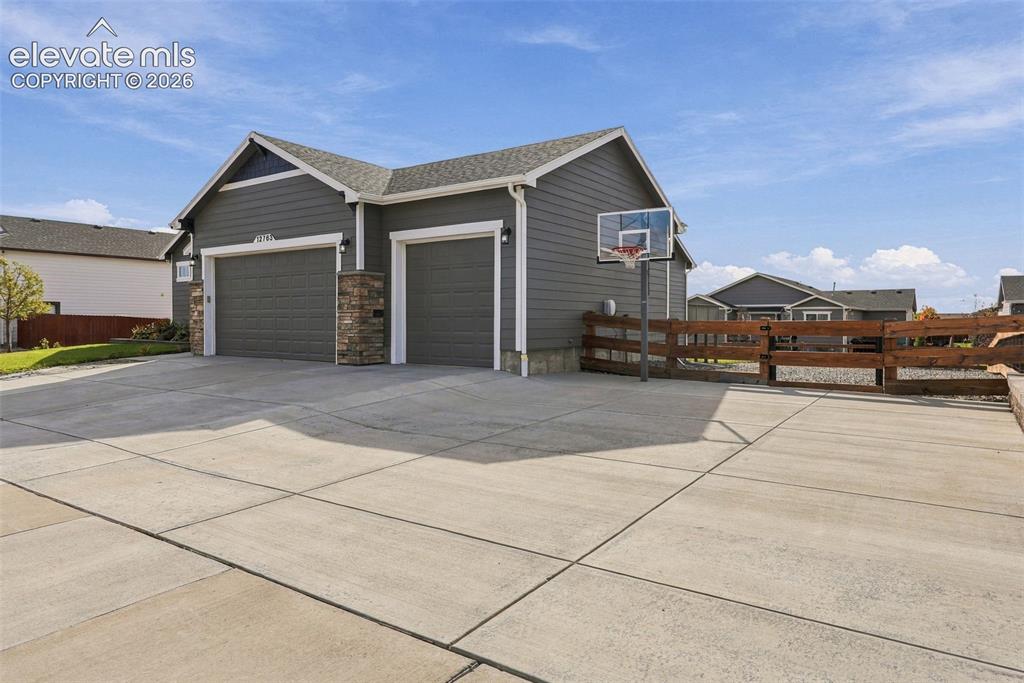 Image 4 of 49: Extended driveway offers generous parking space and room for recreation.
