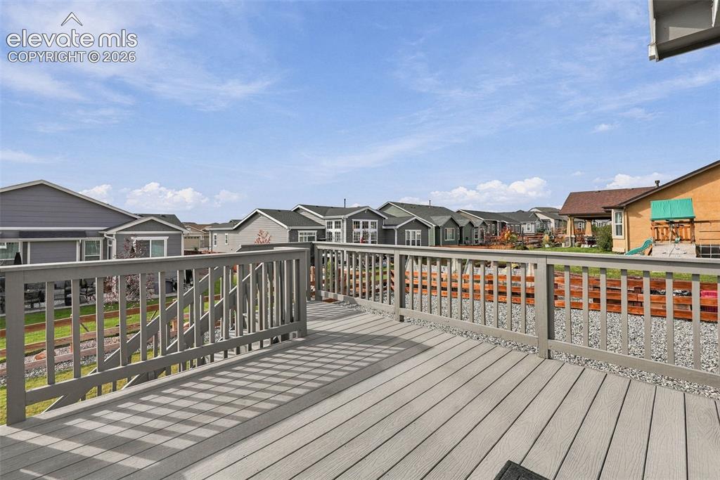Image 40 of 49: Large deck expands the home’s outdoor living and entertaining space.