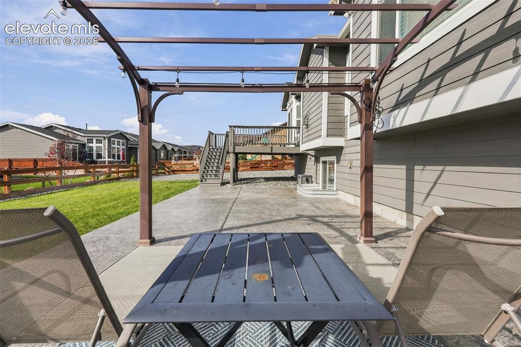 Image 42 of 49: Pergola-covered patio creates another inviting outdoor entertaining area.
