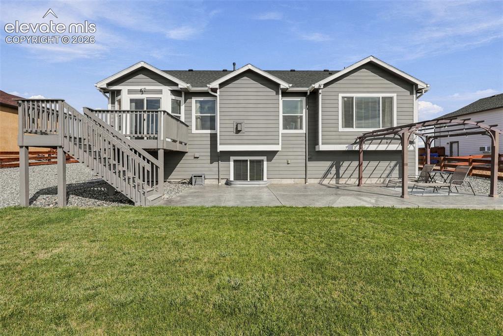 Image 43 of 49: Rear exterior showcases the home’s spacious lot and multiple outdoor living