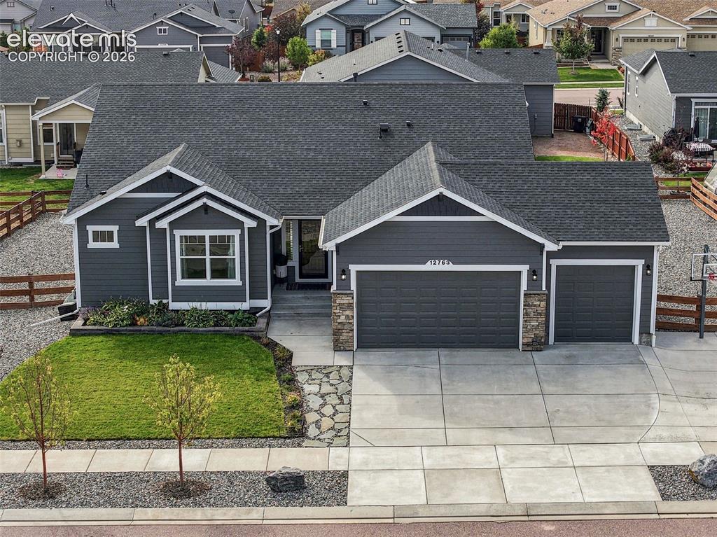 Image 44 of 49: Aerial view highlights the home, three-car garage and surrounding neighborh