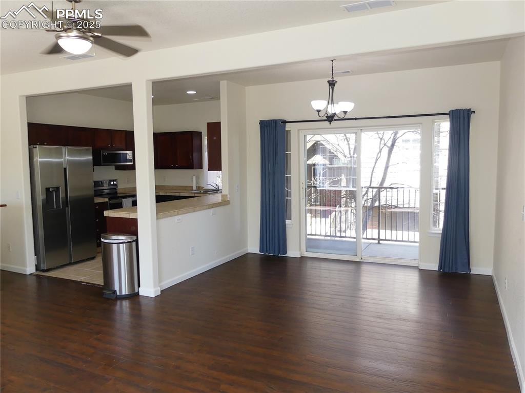 Image 11 of 33: Dining area w/ a walk-out to the covered balcony area