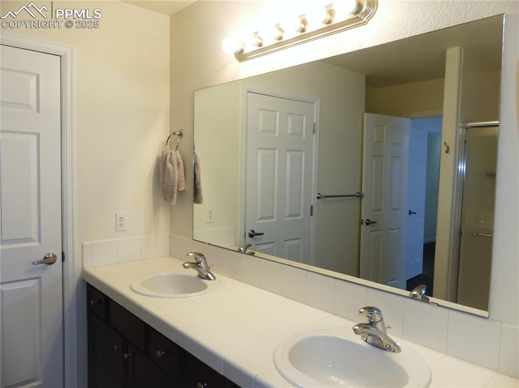 Image 16 of 33: Bathroom featuring a sink and double vanity