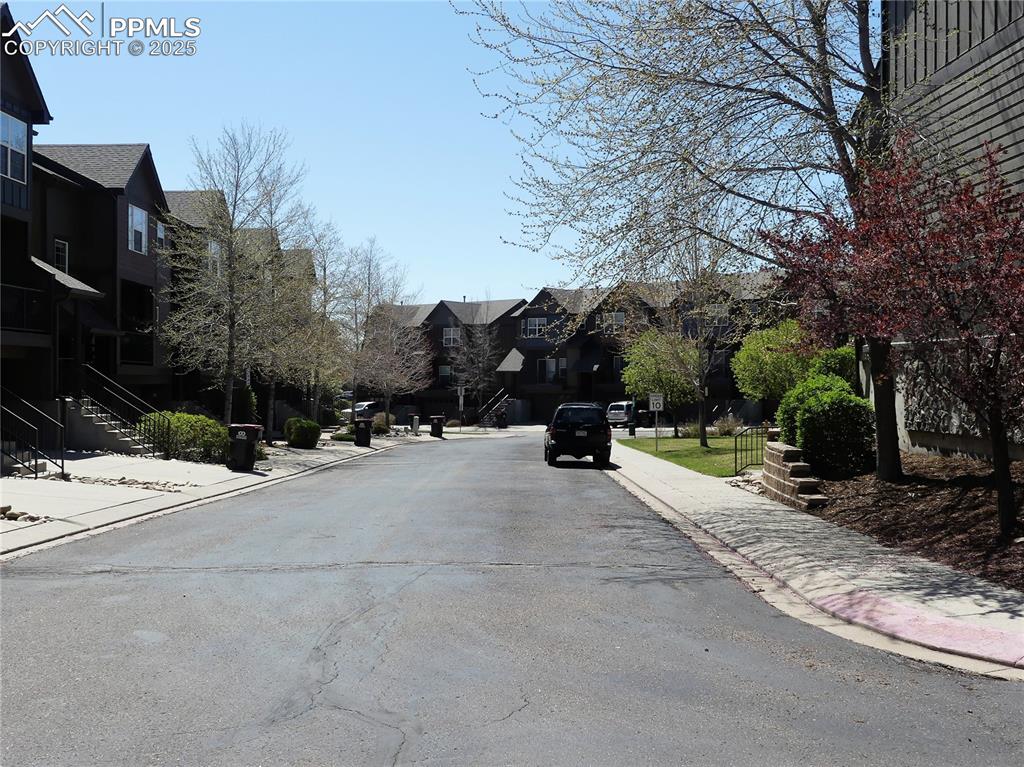 Image 29 of 33: View of road featuring curbs, stairway, sidewalks, and a residential view