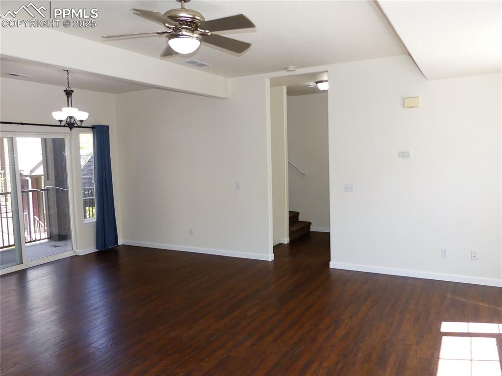 Image 5 of 33: Dining room with baseboards, wood finished floors, stairway, and ceiling fa