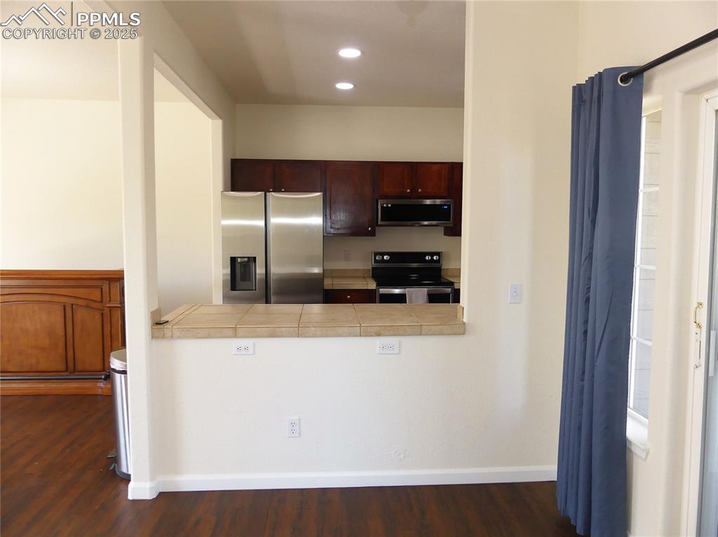 Image 6 of 33: Dining room looking towards the Kitchen featuring appliances with stainless