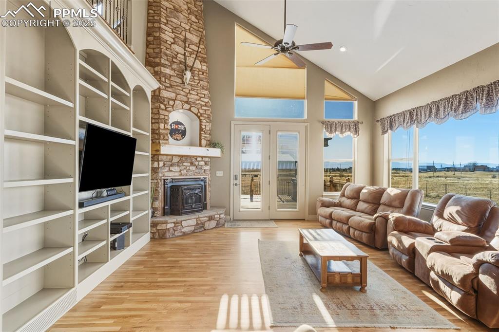 Image 11 of 49: Living area with high vaulted ceiling, healthy amount of natural light, a c