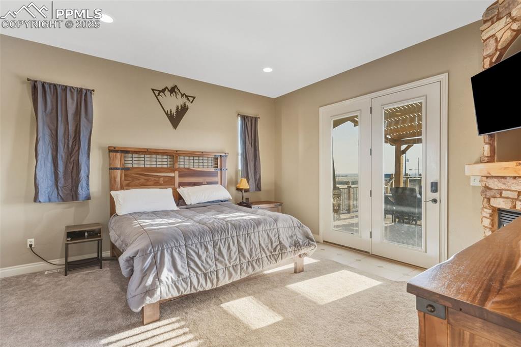 Image 25 of 49: Carpeted bedroom featuring recessed lighting and access to exterior