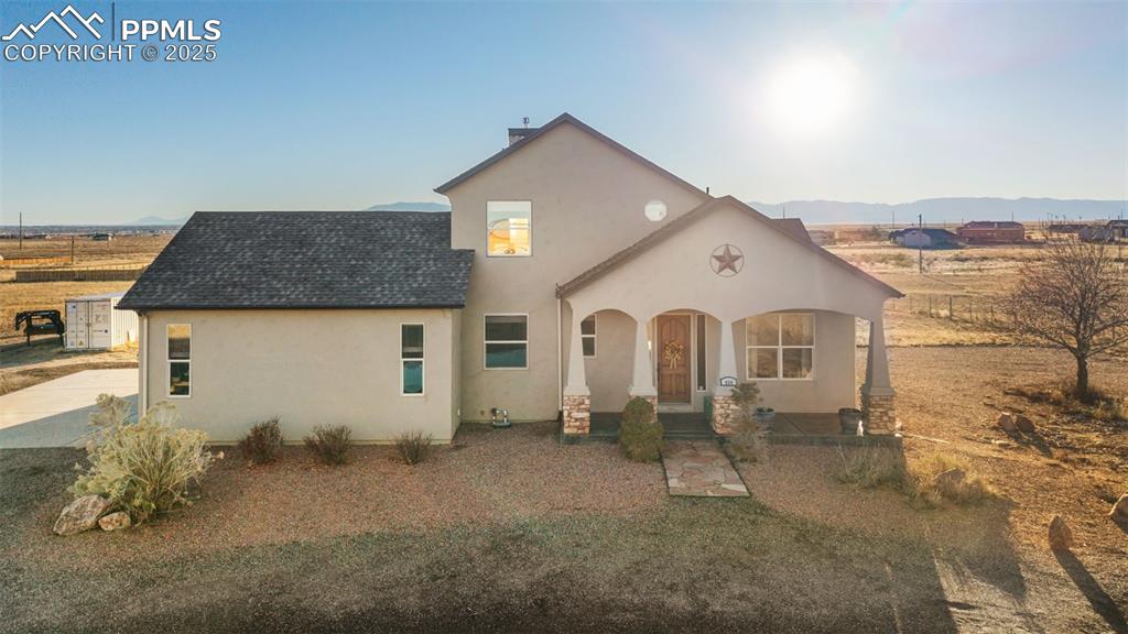 Image 3 of 49: View of front of home featuring stucco siding, a porch, roof with shingles,