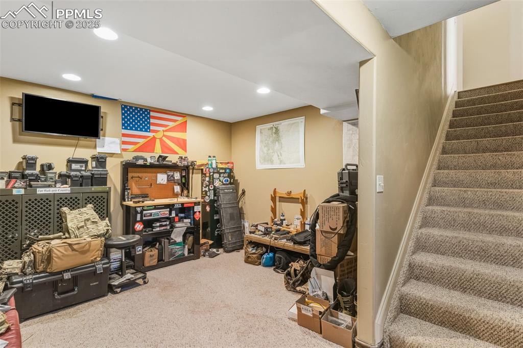 Image 34 of 49: Finished basement featuring stairway, carpet floors, and recessed lighting