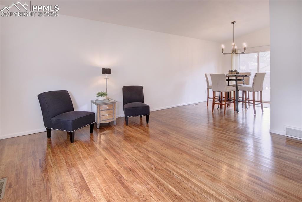 Image 2 of 27: Expansive wood-finish flooring throughout, featuring a bright, open living 