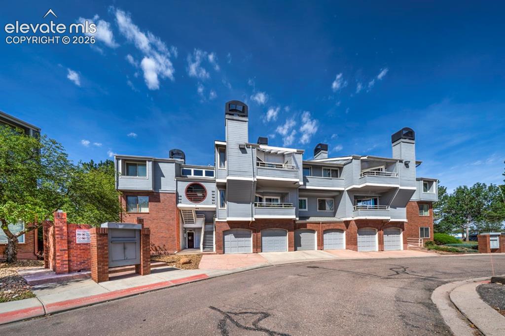 Caption: Brick and siding exterior with multiple balconies
