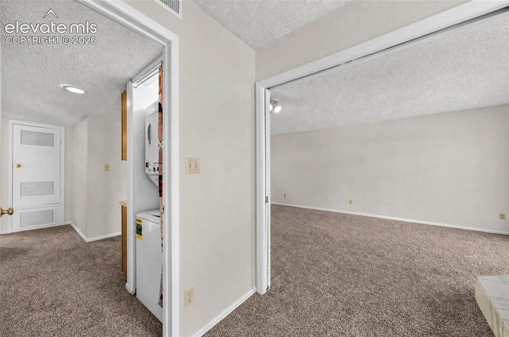 Image 14 of 22: Carpeted flooring, white interior doors, recessed lighting, and a stacked w