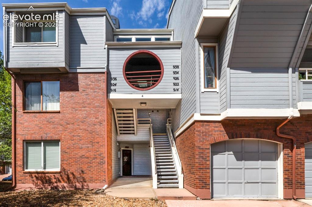 Image 2 of 22: Mixed-material facade featuring brick and horizontal siding