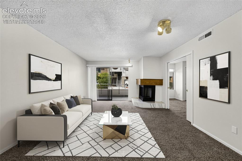 Image 6 of 22: virtually staged used; Living area featuring a fireplace with a light-color