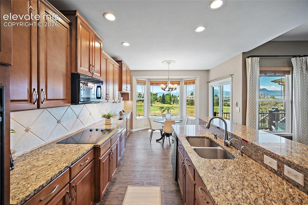 Image 16 of 50: Kitchen with Nook faces west, the golf course and the mountains
