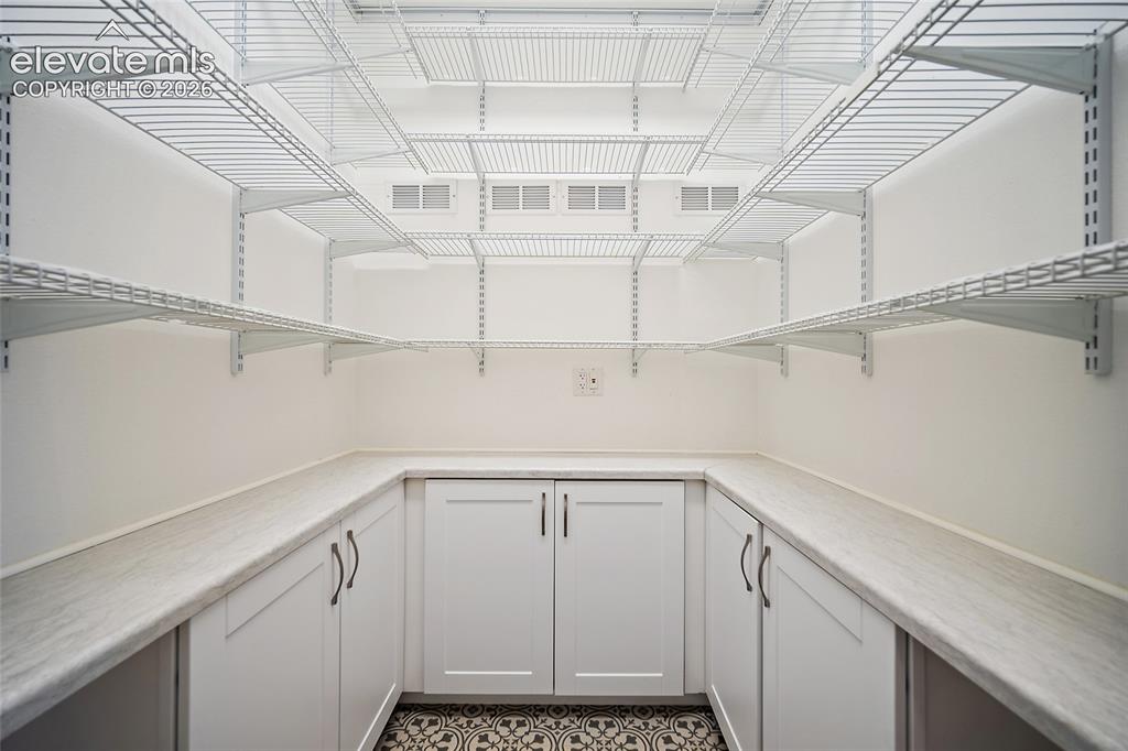 Image 22 of 50: Custom Pantry with plenty of storage.  This was the laundry room