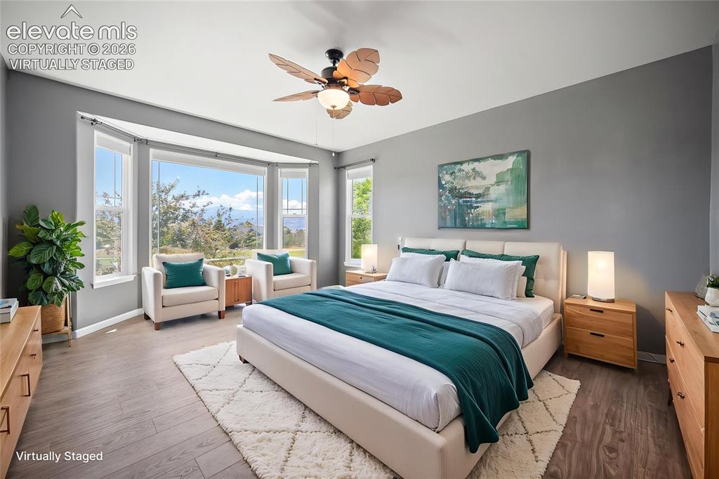Image 28 of 50: Virtually Staged -Primary bedroom faces west - golf course and mountain vie