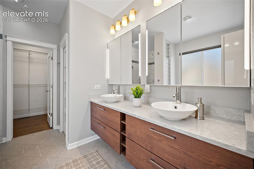 Image 31 of 50: Primary bath has custom oversized dual medicine cabinets