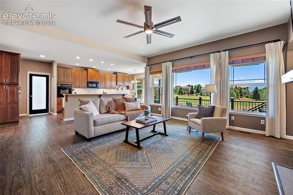 Image 8 of 50: Living Room faces west & has golf and mountain views