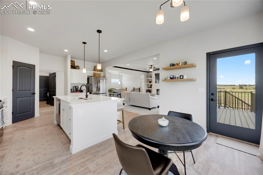 Image 12 of 37: Dining area featuring a ceiling fan, light wood-style floors, and recessed