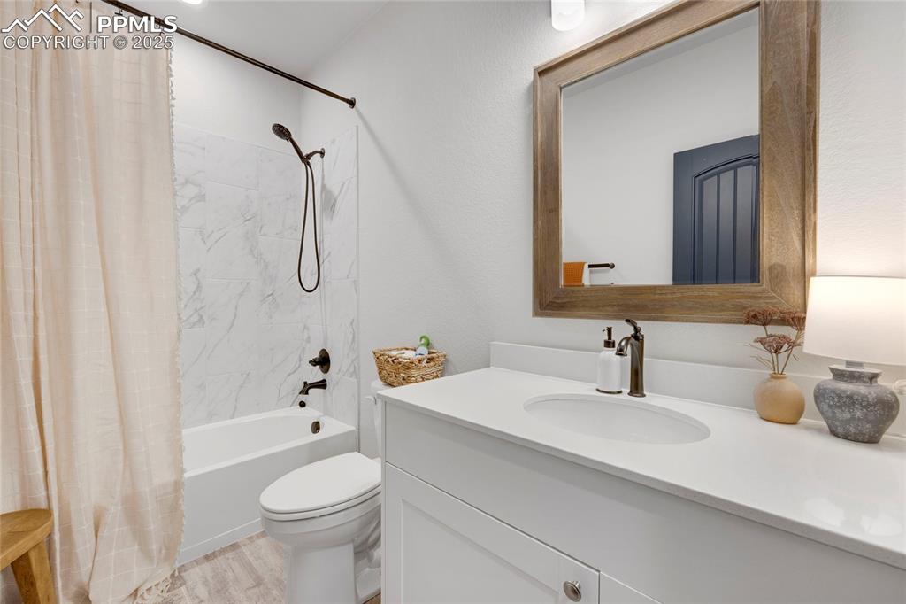 Image 15 of 37: Full bathroom featuring shower / bathtub combination with curtain, vanity,