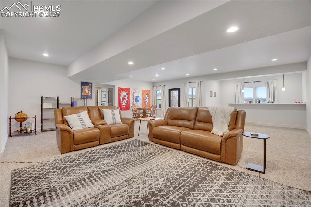 Image 24 of 37: Carpeted living area featuring recessed lighting and baseboards