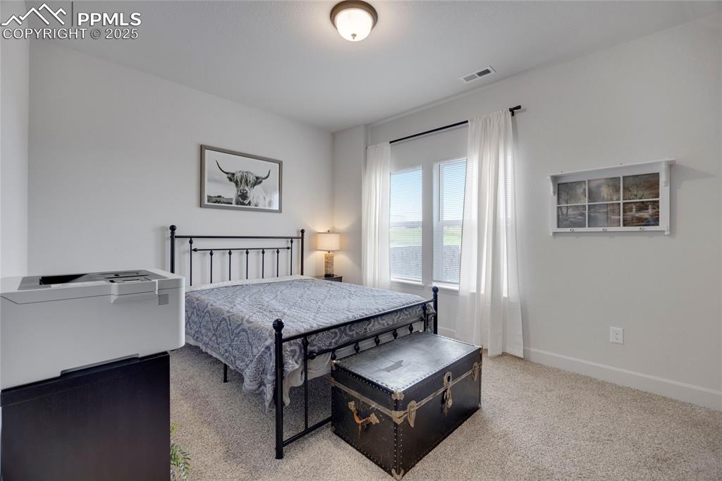 Image 27 of 37: Bedroom featuring light colored carpet and baseboards