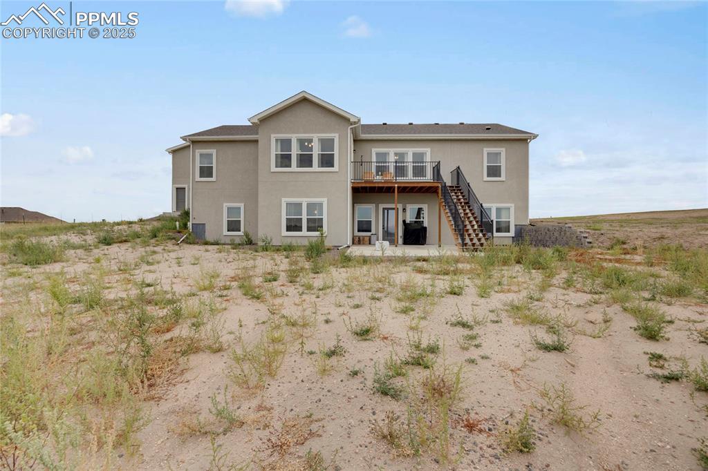 Image 36 of 37: Back of property with a patio, stairs, stucco siding, and a deck