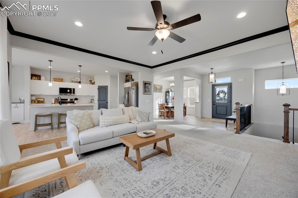Image 5 of 37: Living room featuring light carpet, ceiling fan, recessed lighting, and orn