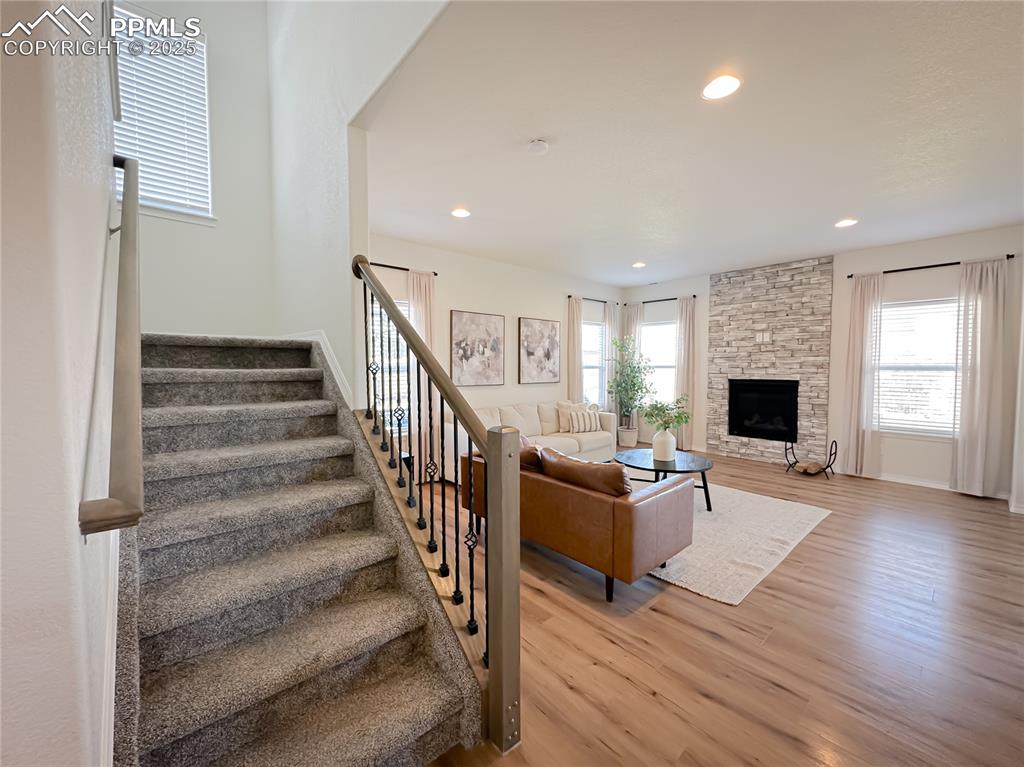 Image 14 of 42: Living room featuring plenty of natural light, stairway, light wood-style f