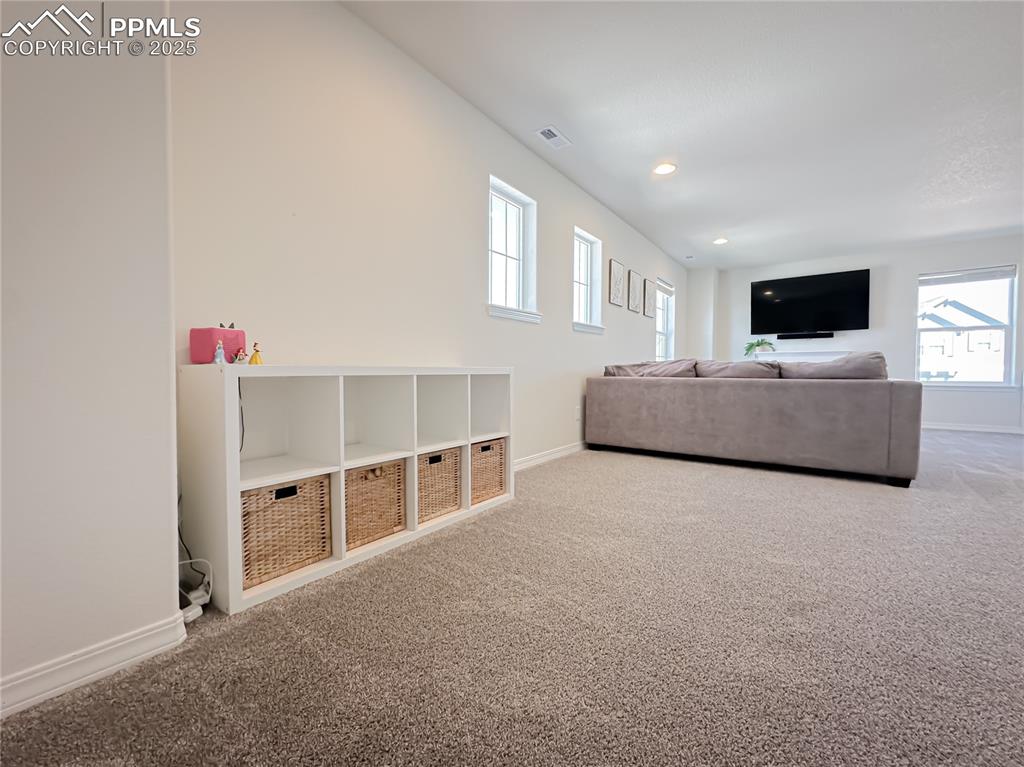 Image 22 of 42: Carpeted living room featuring healthy amount of natural light and recessed