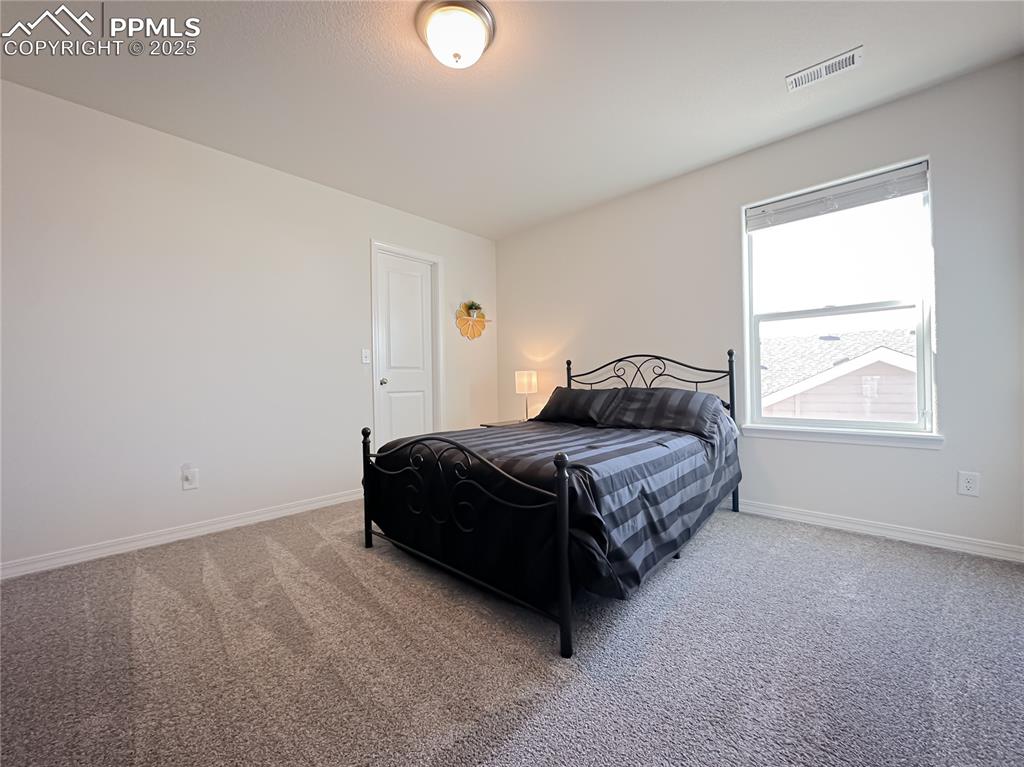 Image 31 of 42: Carpeted bedroom featuring baseboards