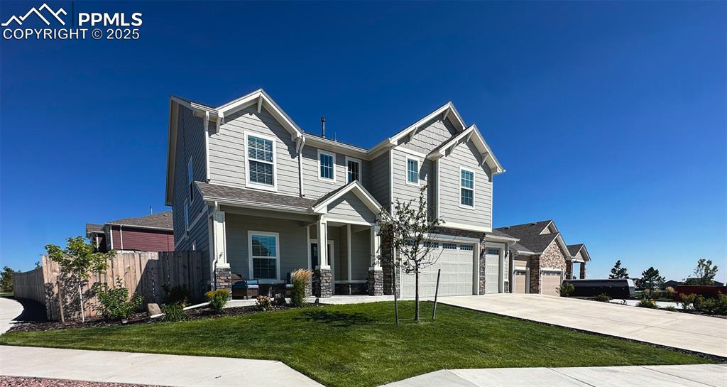 Image 4 of 42: Craftsman inspired home featuring a porch, concrete driveway, stone siding,