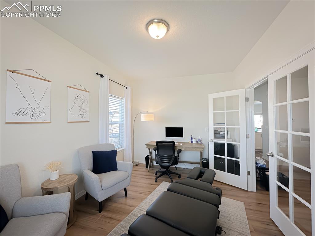 Image 9 of 42: Home office featuring french doors and wood finished floors