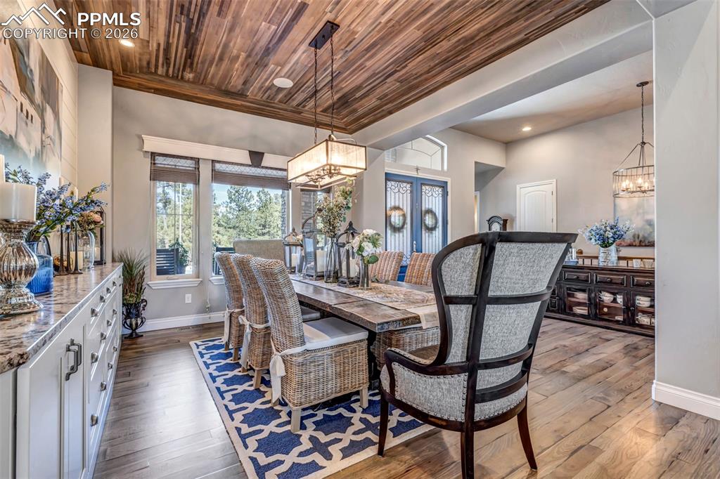 Image 13 of 50: Entryway with a chandelier, french doors, and light wood-style floors
