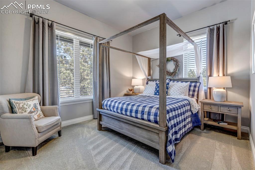 Image 15 of 50: Dining space with a high wood ceiling, suspended lighting, a fireplace, and