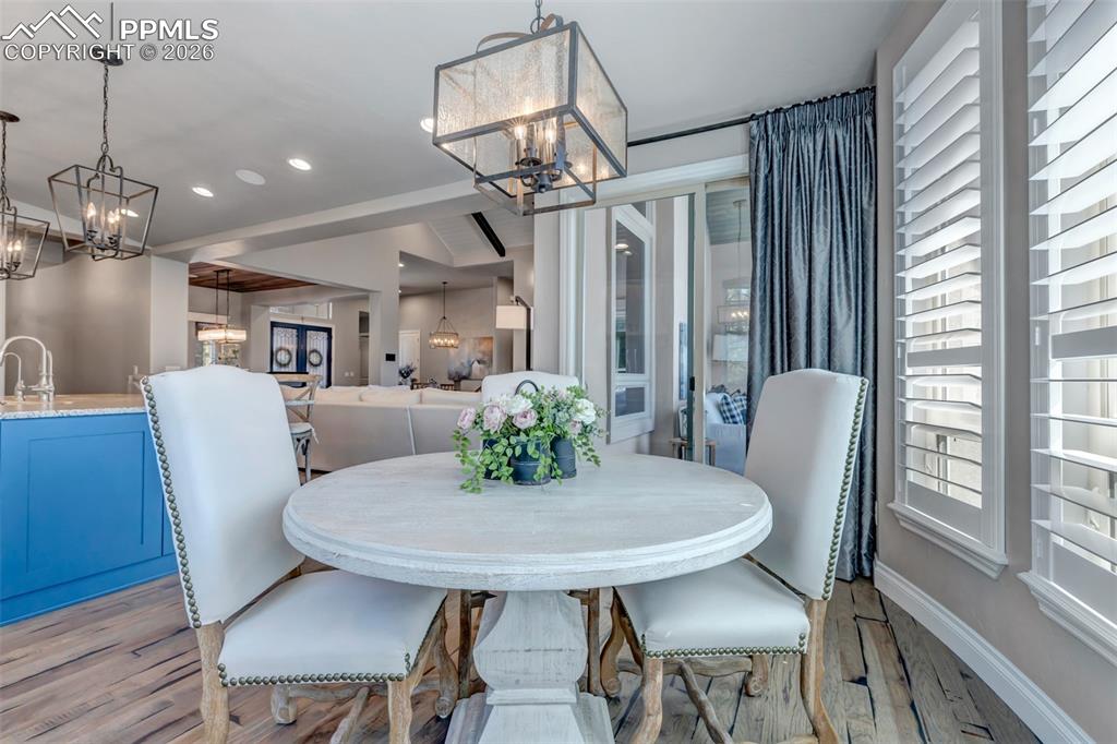 Image 26 of 50: Kitchen with stainless steel appliances, beverage cooler, white cabinets, l
