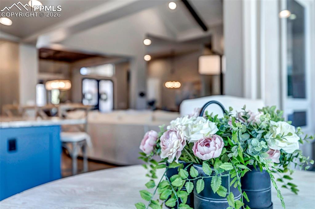 Image 27 of 50: Kitchen with light stone countertops, stainless steel appliances, dark wood
